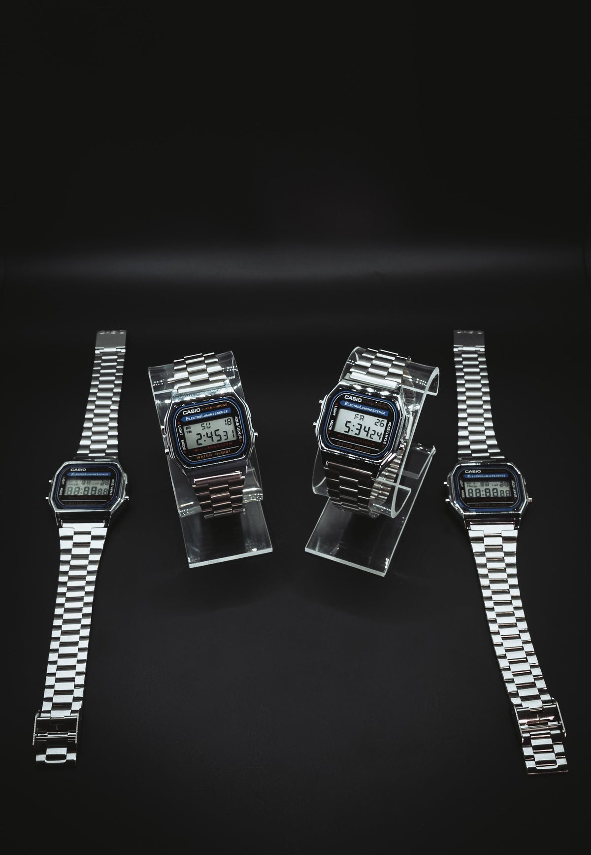 Casio A168 watches laid out with bracelets open
