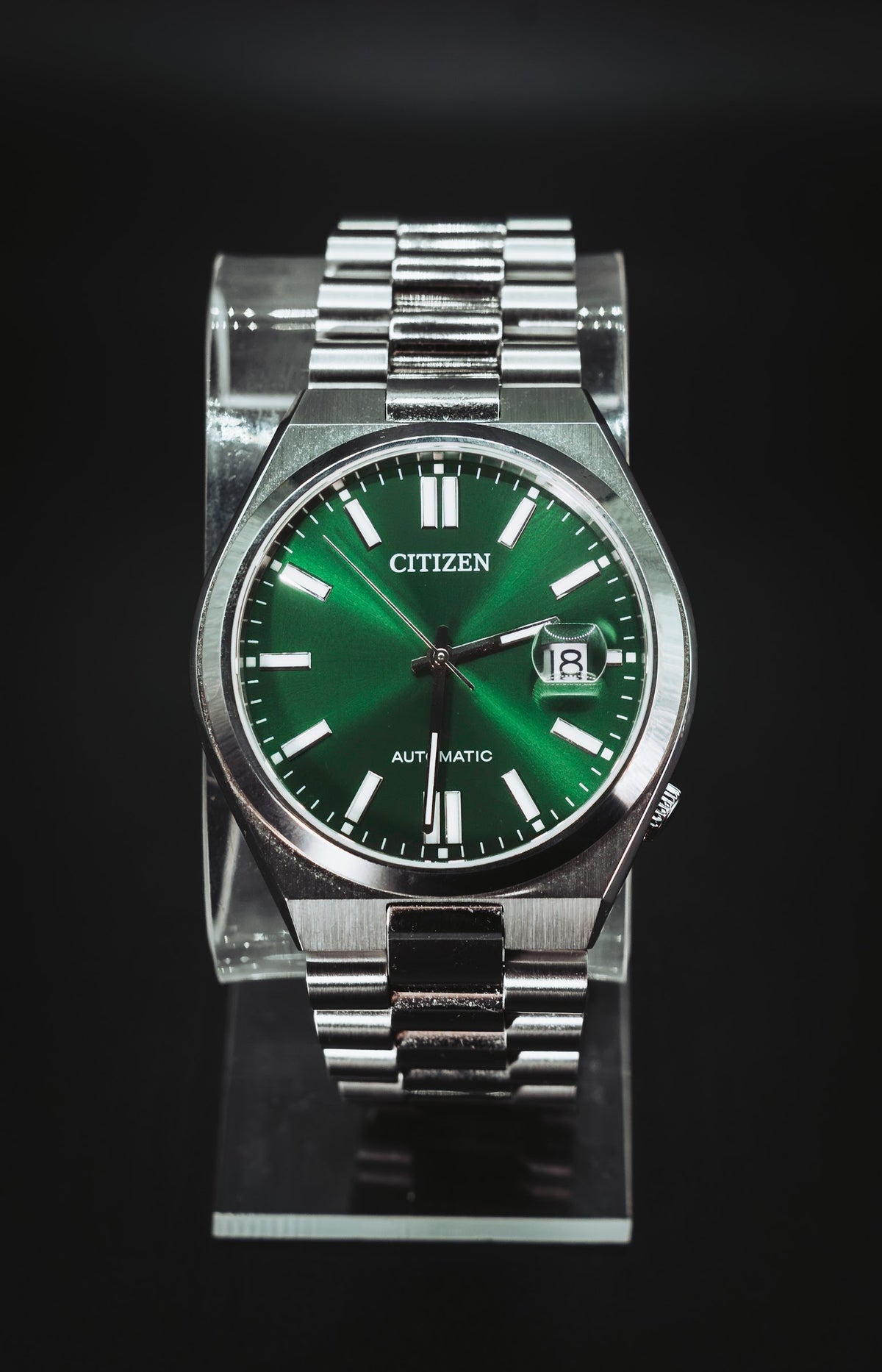 Citizen Automatic green dial on a clear display stand