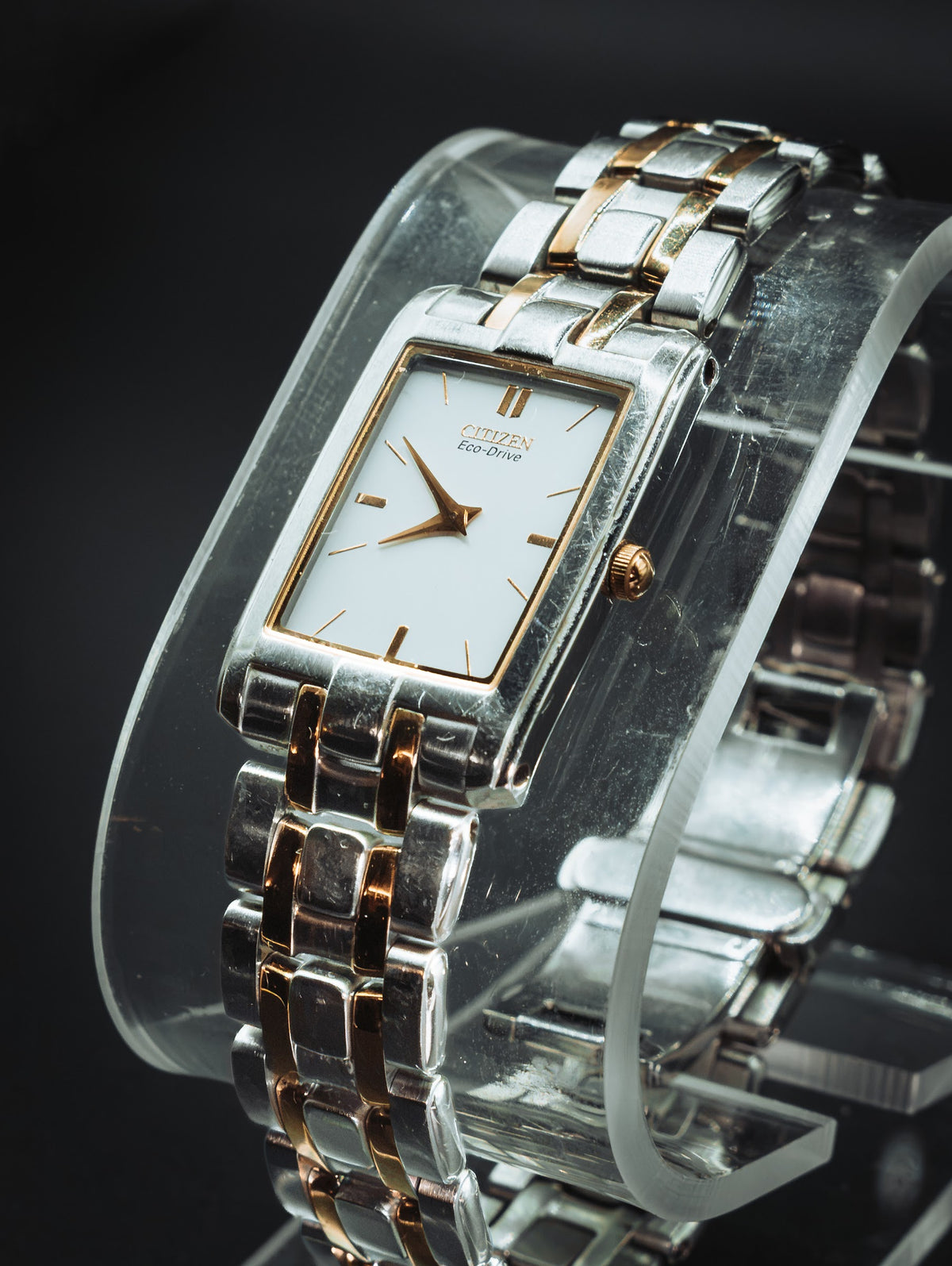 Citizen Eco-Drive rectangular watch with a white dial on a two-tone bracelet