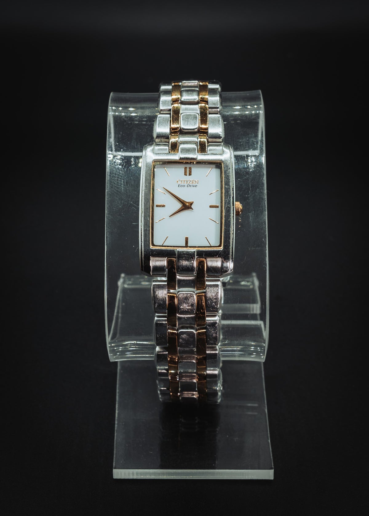 Citizen Eco-Drive rectangular on a clear display stand