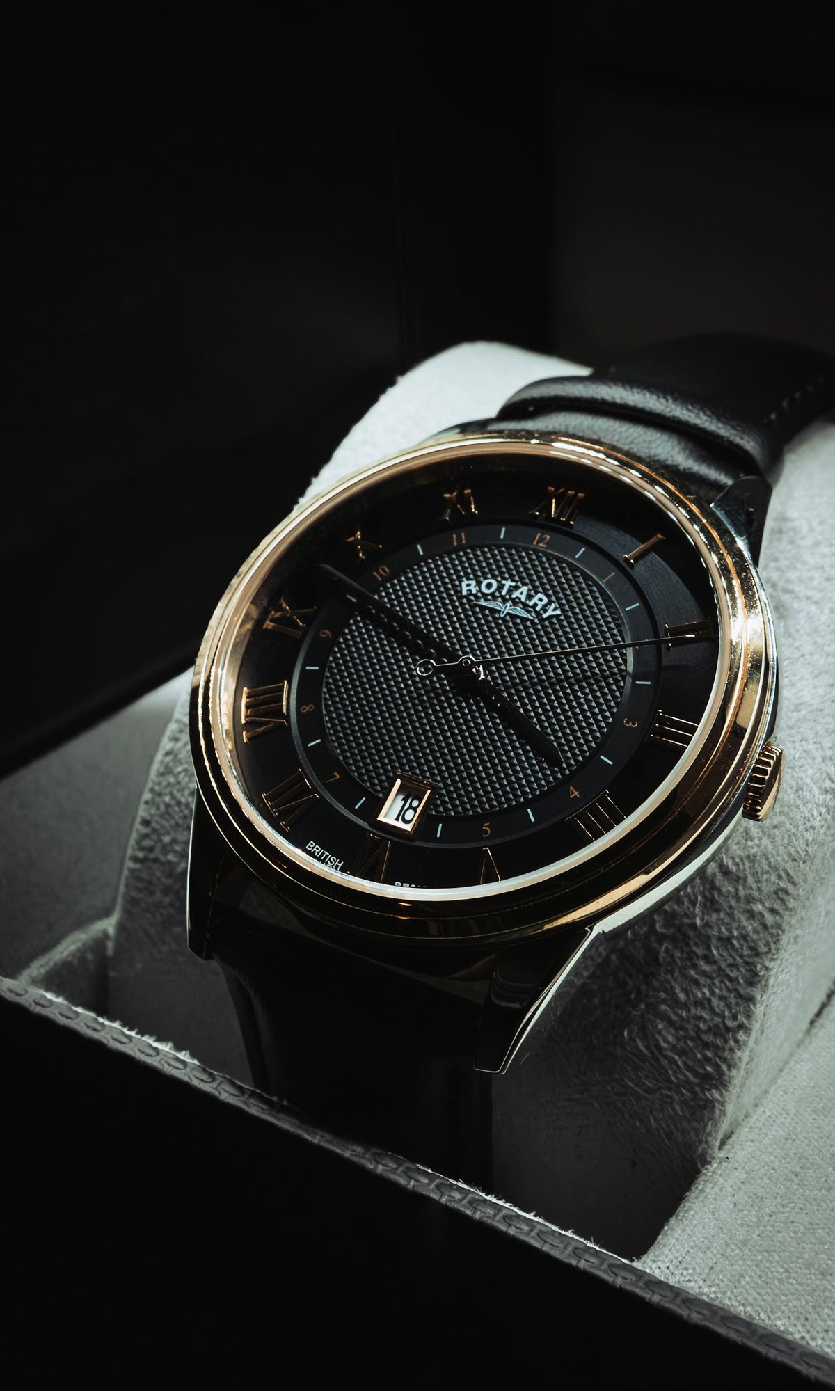 Rotary with a black textured dial, Roman numerals and a rose-gold-tone bezel