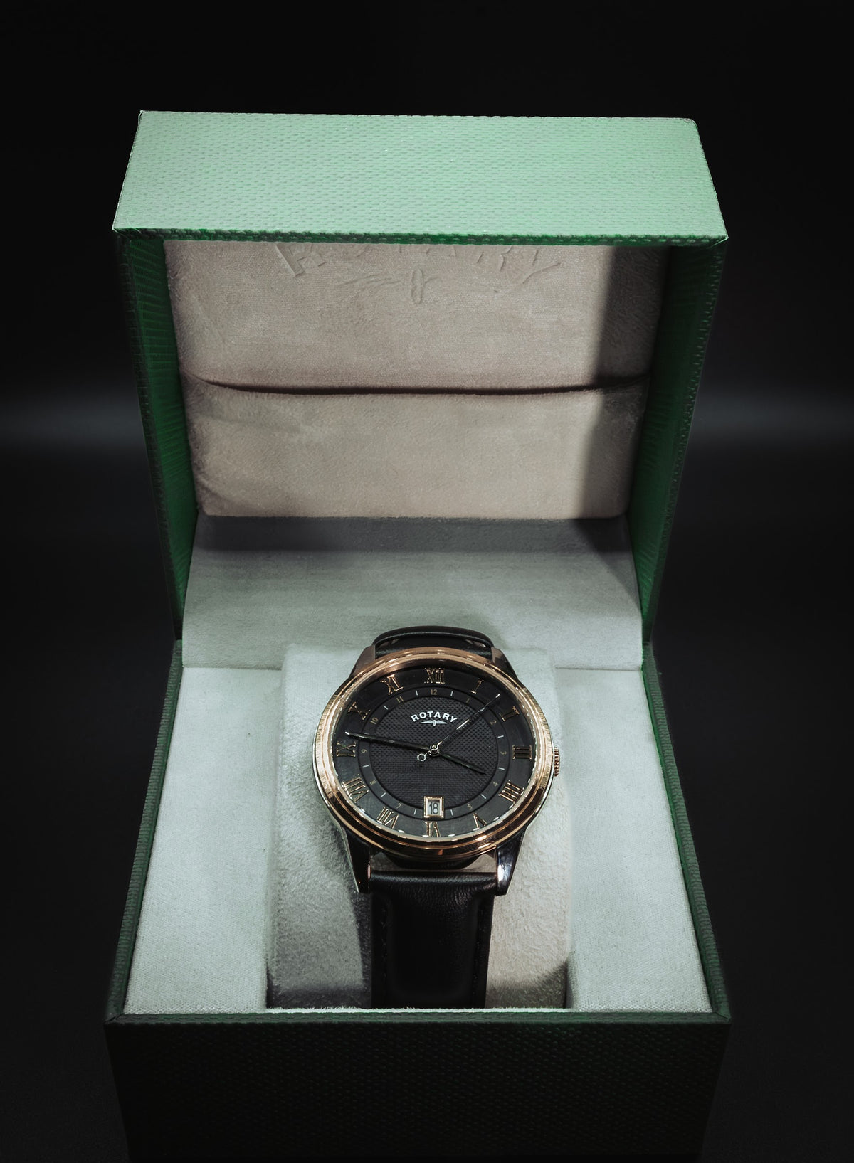 Rotary black dial in its green presentation box