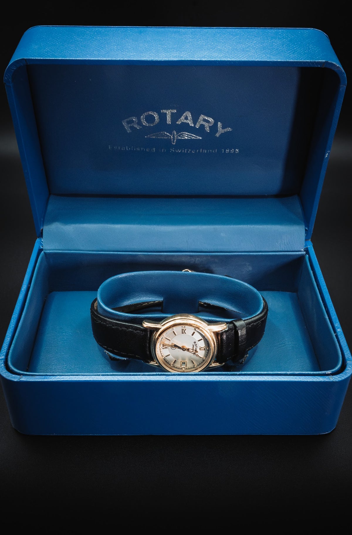 Gold-tone Rotary in its blue presentation box